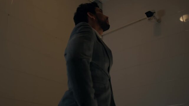 Man in cell feeling worried, contemplative and tense mood