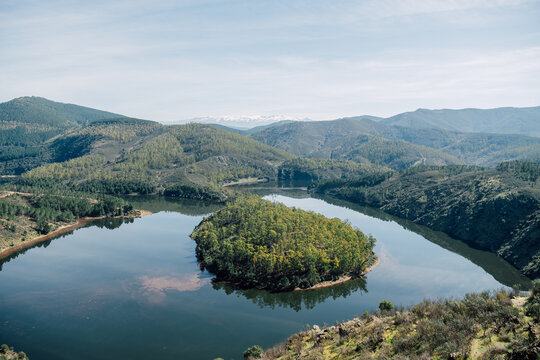 Aerial view of Melero meander river curve with forest island landscape
