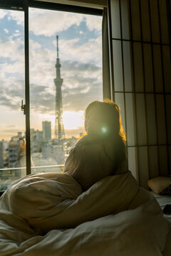 Woman in Bed With Tokyo Sky Tree View From Her Window