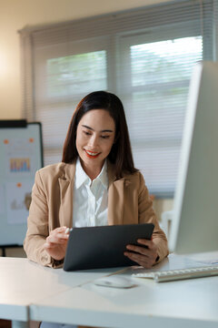 Businesswoman reviews digital data on device