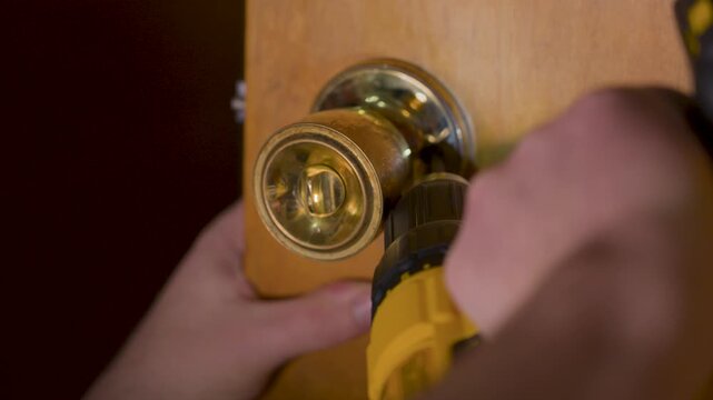 Forcing the removal of a stubborn screw on a door handle.