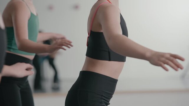 Young talented girls tap dancing routine in a modern dance studio