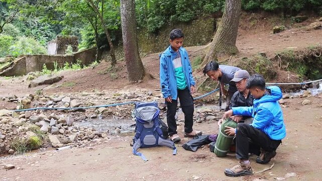 Young Campers cheking camping gear before setting up their tents