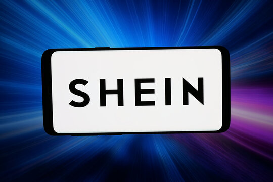 Stuttgart, Germany - 03-16-2026: In this photo illustration, the logo of Chinese fast fashion e-commerce company Shein is displayed on a smartphone in front of abstract background on computer screen.