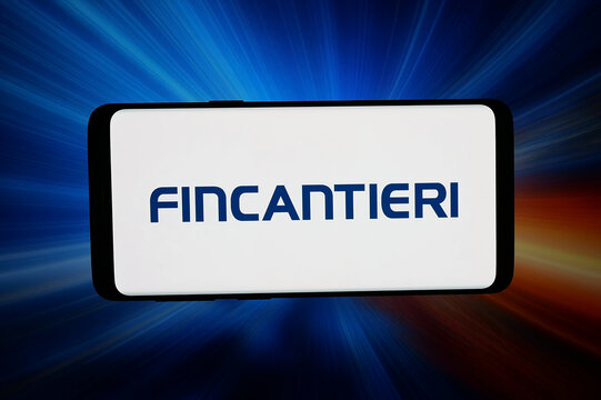 Stuttgart, Germany - 03-16-2026: In this photo illustration, the logo of shipbuilding company Fincantieri S.p.A. is displayed on a smartphone in front of abstract background on computer screen.