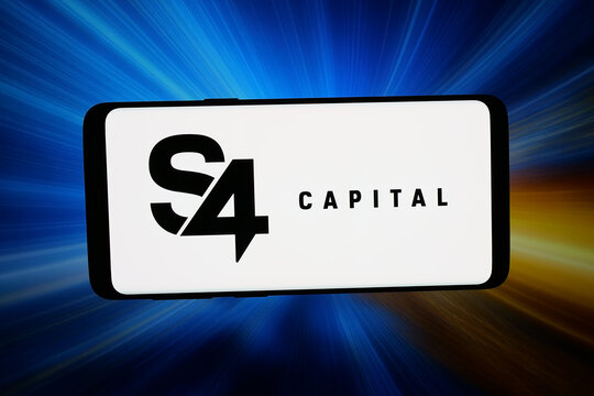 Stuttgart, Germany - 03-16-2026: In this photo illustration, the logo of British advertising company S4 Capital plc is displayed on a smartphone in front of abstract background on computer screen.