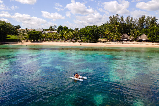 Serene couple kayaking on the crystal-clear waters of Triolet in Mauritius