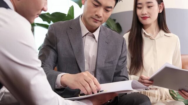 Two successful confident businessman signing contract document deal, Two Self-Assured Male Business Partners Sign Contractual Agreement During Negotiations Meeting in Boardroom. Partners shaking hands