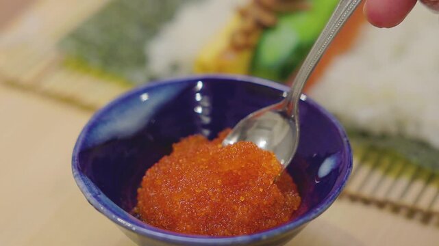 Close-up of tobiko being scooped with a spoon