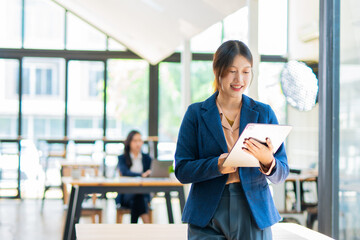 A successful Asian businesswoman, looking confident and smiling. © panomporn