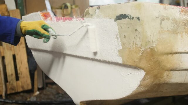 Applying white paint to fiberglass boat transom