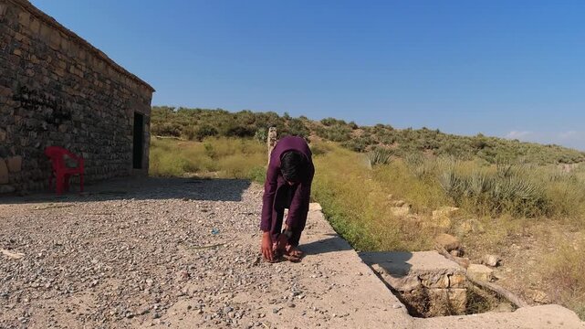 An Afghan young boy wears traditional rattan, rotan footwear, showcasing indigenous ratan craftsmanship and cultural significance of the region, Afghanistan