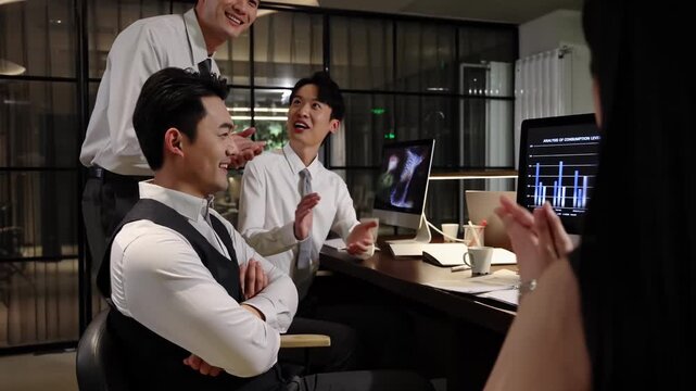 Group of businesspeople around computer table having strategic planning session, , celebrating collective achievement the successful completion of a project with enthusiastic cheers in modern office