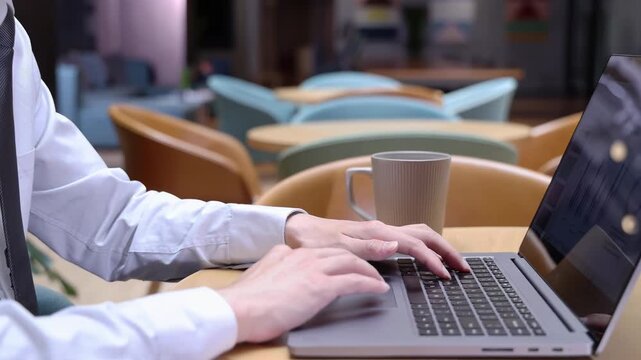Focused busy businessman in formal suit analyzing data meticulously works on a laptop, reviewing data and navigating the digital landscape with determination. Worker ceo manager using laptop computer