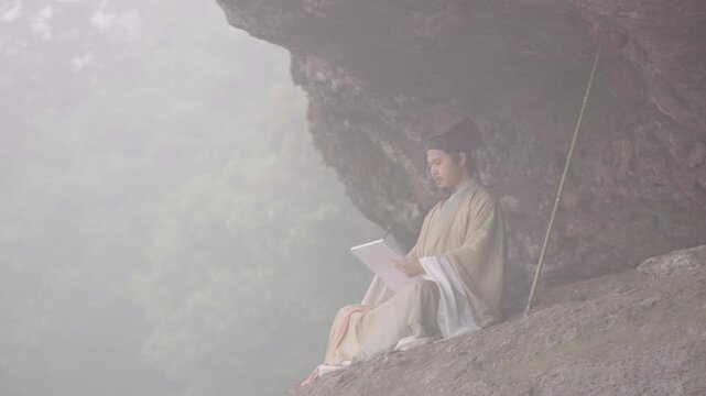 A Ming Dynasty Chinese scholar (resembling Wang Yangming) in Hanfu sits in a misty cliff cave, focused on writing with a traditional brush. A serene scene blending Chinese philosophy, cultural heritag