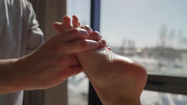 Relaxing professional foot massage therapy session with close-up hand techniques focusing on toes, arch, and heel in a calming natural light wellness setting