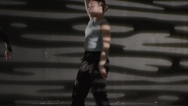Young modern girls in dance class performing