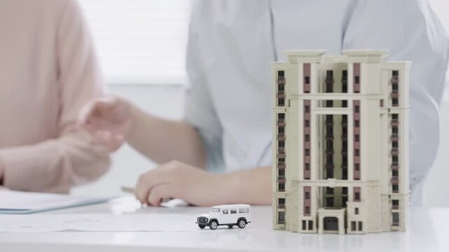 Property manager, businessman discuss contract details, clients signing mortgage agreement in bank office. Concept of home loan, real estate, automobile investment, insurance, buying own property