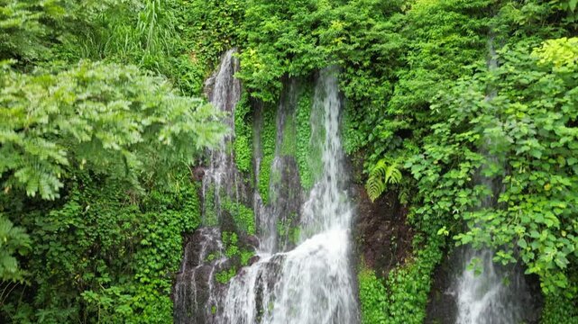 Man Standing In Tropical Waterfall Pool East Java Indonesia Drone Rise 4K 30FPS