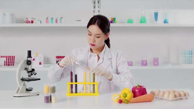 Food scientist studies seeds working with samples of different grains cereals for development of gmo products, laboratory assistant in a protective suit research and analysis of soy soybeans in lab