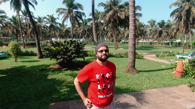 Indian man taking a casual walk inside Candolim Beach Resort Goa, enjoying slow motion moments