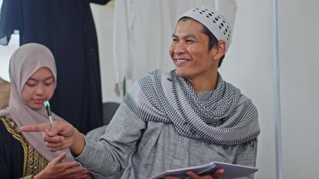 Cheerful Muslim man in traditional clothing lists luggage for Eid homecoming