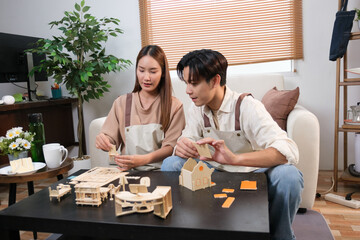 Fototapeta premium A young Asian couple spend time together at home