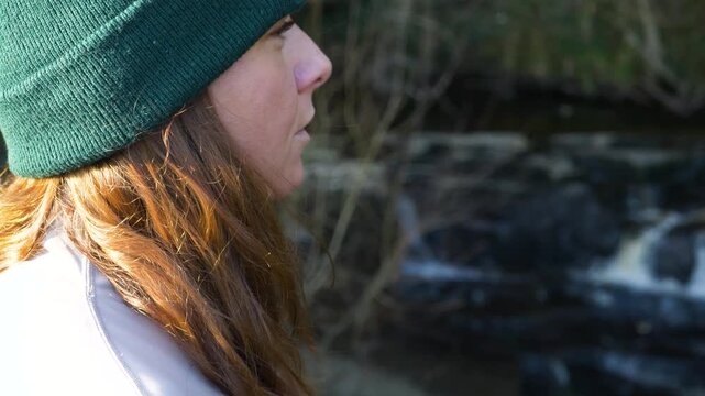 A Woman Is Vaping In The Forest Of Cathole Falls In County Laois, Ireland. Close-up Shot