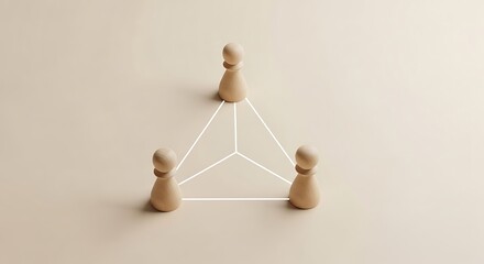 Obraz premium Three wooden game pieces are connected by white lines to form a triangle on a flat surface with one piece on top.