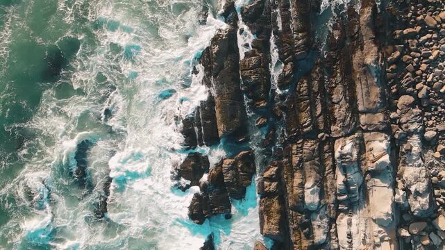 Aerial View of Rock Covered Shoreline Pummeled by Waves