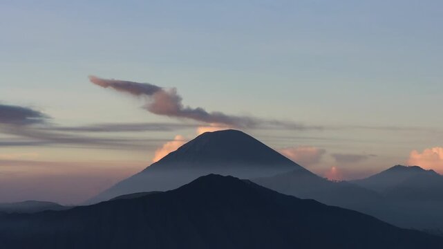 Wide shot of Sunrise Eruption of Mount Semeru with Flowing Ash Plume from King Kong Hill in East Java, Indonesia