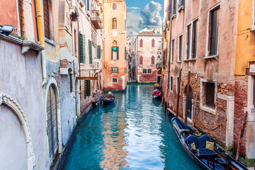 romantic view of a canal in Venice with boats and blue water and beautiful vintage buildings around the cityscape © Yaroslav