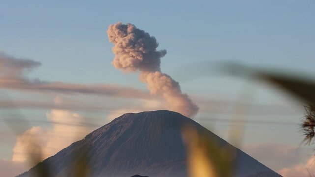 Wide shot of Sunrise Eruption of Mount Semeru Framed by Foreground Silhouettes from King Kong Hill in East Java , Indonesia