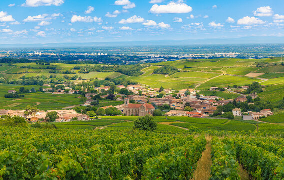 Panoramic view of Fleurie village surrounded by rolling vineyards in the Beaujolais wine region, France