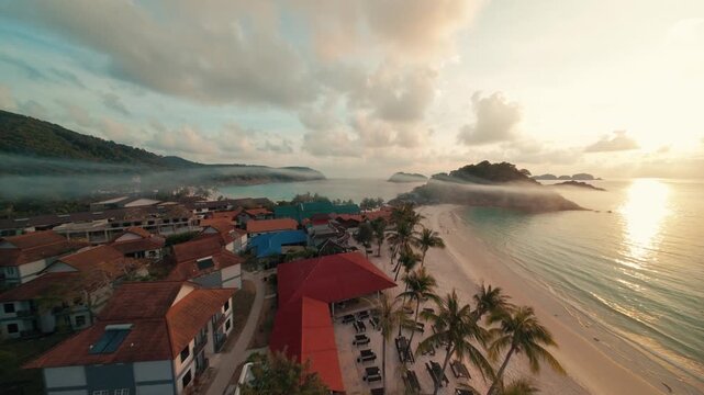 Fast cinematic FPV drone footage cruising low over the sandy coastal beach and ocean waves of Redang Island during a beautiful golden sunrise