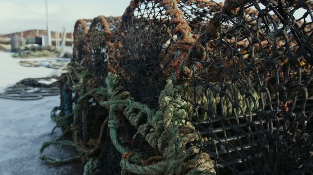Close up, slider shot of fishing creels stacked on Bernera pier on the Hebrides.