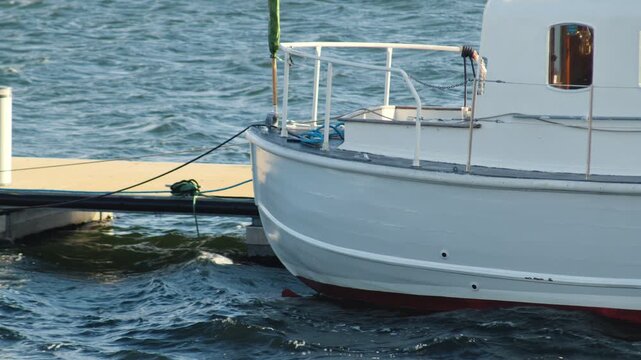 Static shot of the rear end of a pleasure boat docked at Bernera pier.