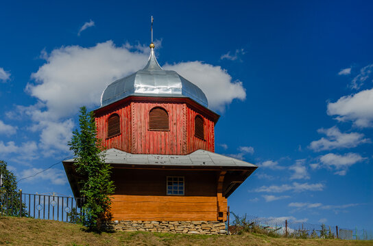 Red Hutsul Wooden Church with Onion Dome in Carpathians