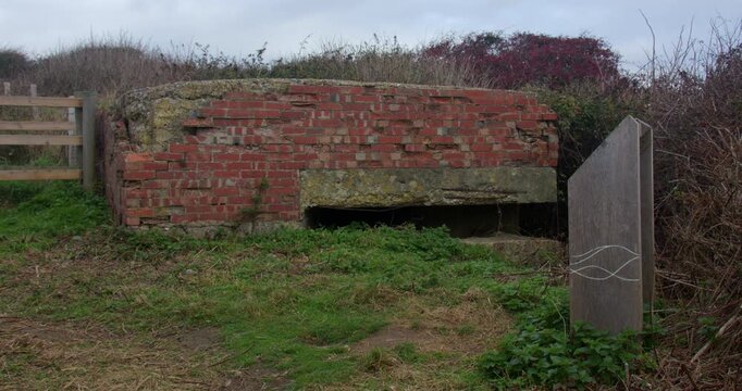 Wide shot of a World War 2 pillbox at Seaford head next to seven sisters, cliffs,