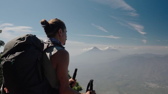 Hiker overlooking Atitlan volcanoes from Acatenango summit Guatemala