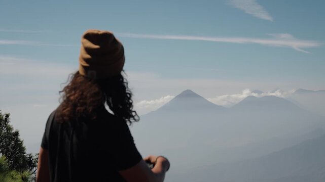 Traveler admiring Atitlan and Toliman volcanoes from Acatenango