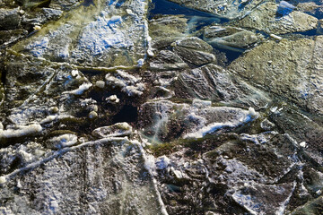 Fototapeta premium Broken Ice Floes on Dark Water in Winter