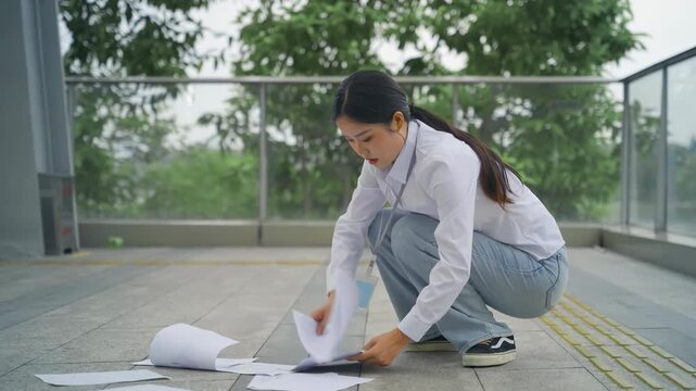 Failed unhappy businesswoman drops lets down documents, working woman tidying up, picking up fallen paper. Concept work problem, office stress syndrome, economic recession, layoff, unemployment