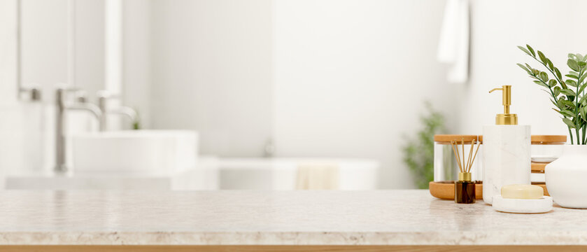 Soap and body wash and diffuser on white marble counter table across tub and sink in modern bathroom