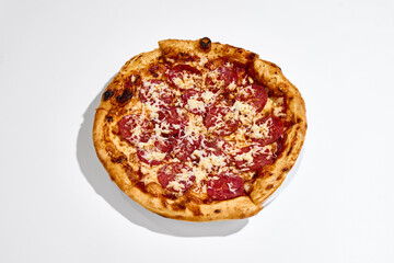 Fototapeta premium Pepperoni pizza top view placed on white plate on clean white background. Concept of food delivery, sharing meal, group dining, takeaway menu and restaurant promotion.