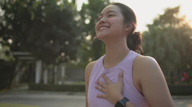 Asia young Gen Z people mindful happy woman open arm relax body deep stress relief outdoor nature green public park sun light self love anti aging life asian female mental health care modern medical.