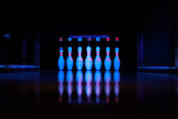 Bowling Alley Pins Set, lit with UV light and a Blue Tone. © Camilla