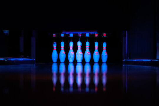 Bowling Alley Pins Set, lit with UV light and a Blue Tone.