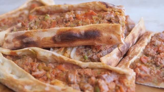 Close up of delicious Turkish pide with meat filling served on a wooden board