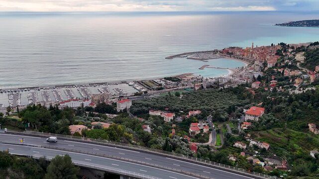 Scenic aerial view of menton with highway traffic and marina